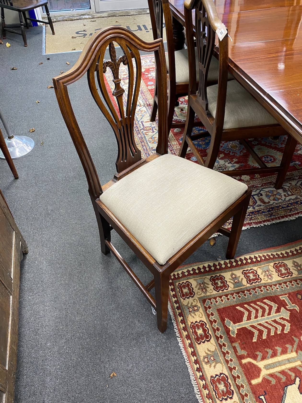 A late Victorian mahogany extending dining table, length 209cm extended with two spare leaves and winder, depth 106cm, height 76cm together with a set of eight Hepplewhite style dining chairs, two with arms